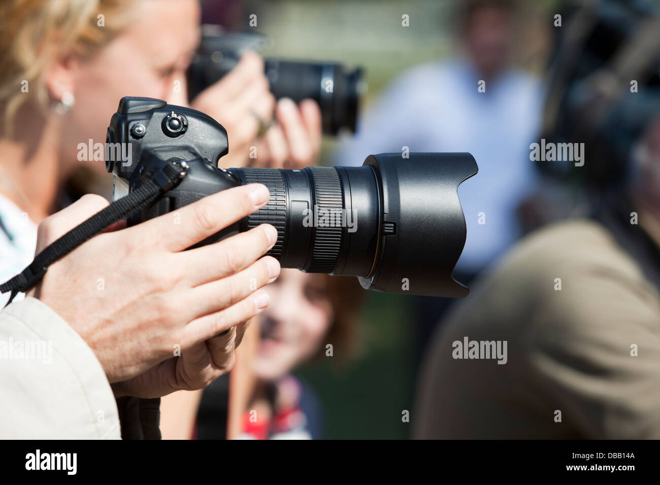 photographer holding camera Stock Photo - Alamy