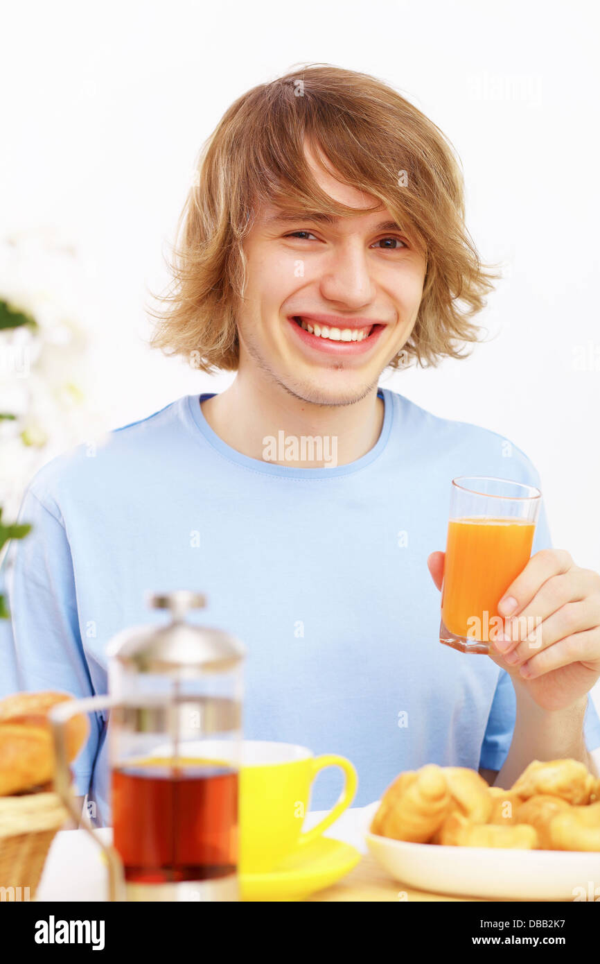 Young man drinking juice Stock Photo Alamy