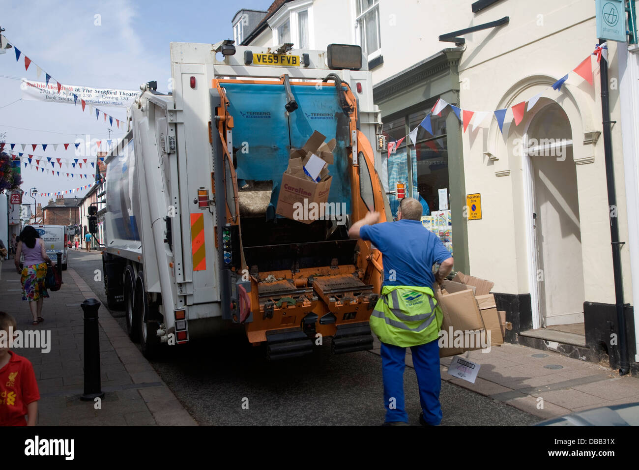 Refuse collection vehicle and men collecting rubbish for recycling The Thoroughfare street Woodbridge Suffolk Stock Photo