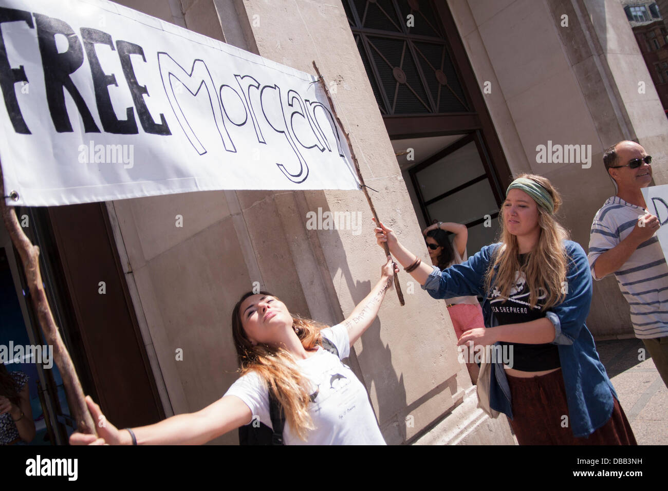 London, UK. 27th July 2013. Two women with their banner as protesters in London and around the world demonstrate against marine mamals held captive for entertainment. Credit:  Paul Davey/Alamy Live News Stock Photo