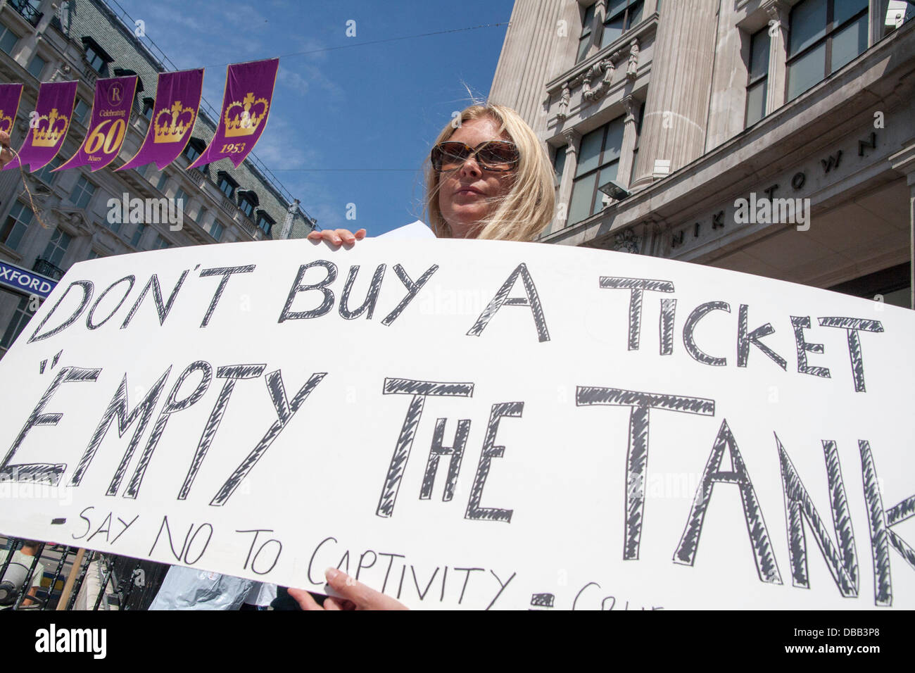 London, UK. 27th July 2013. A banner urges people not to visit marine parks as protesters in London and around the world demonstrate against marine mamals held captive for entertainment. Credit:  Paul Davey/Alamy Live News Stock Photo
