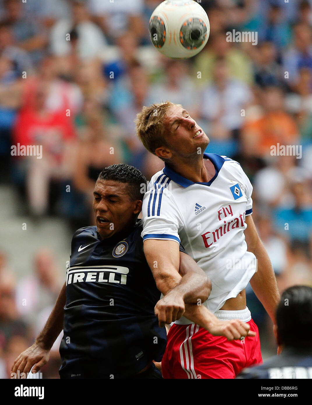 Milan's Juan Jesus (L) vies for the ball with Hamburg's Lasse Sobiech during the test match between Hamburger SV and Inter Milan at Imtech Arena in Hamburg, Germany, 27 July 2013. Photo: AXEL HEIMKEN Stock Photo