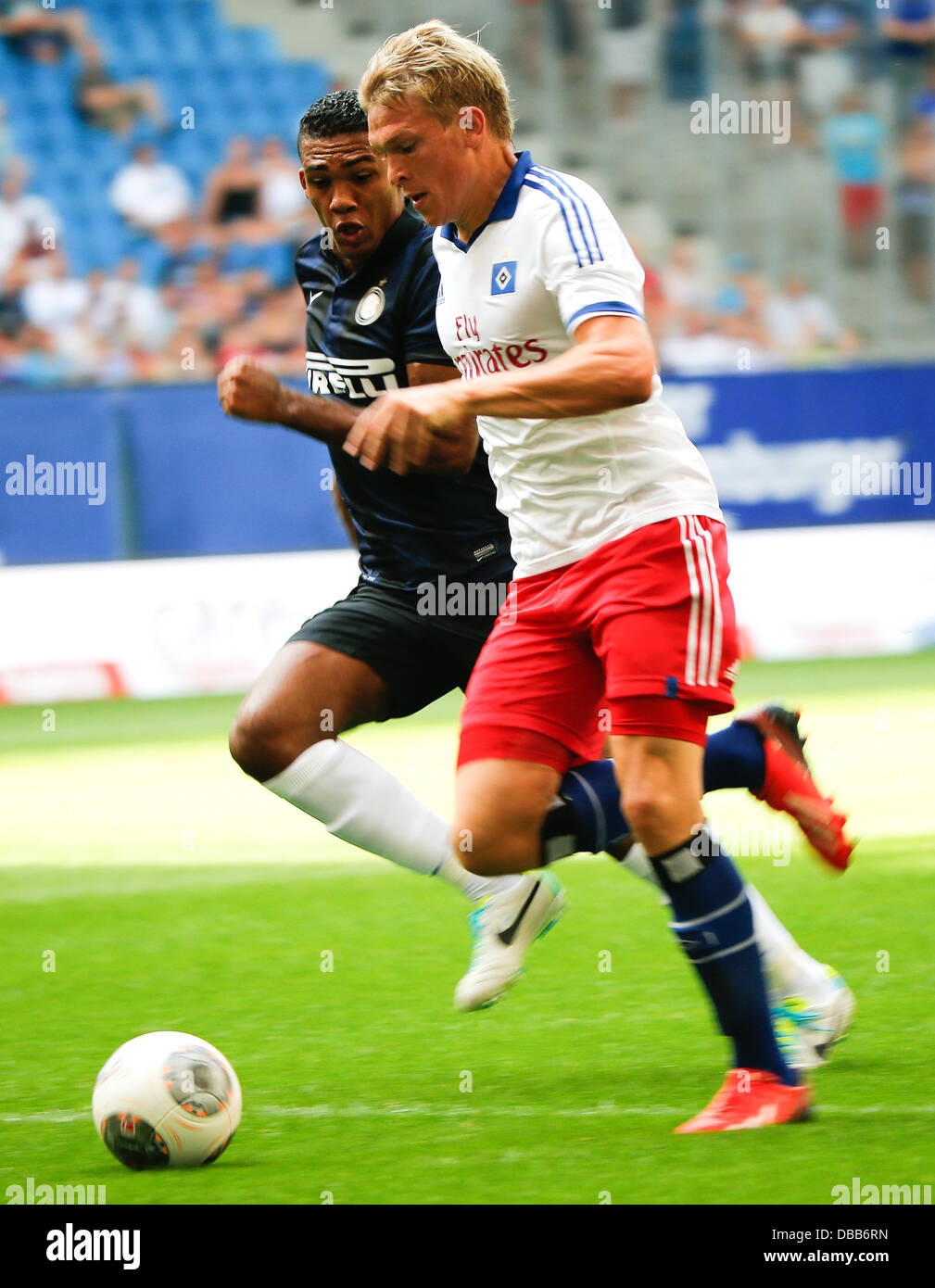 Milan's Juan Jesus (L) vies for the ball with Hamburg's Artjoms Rudnevs during the test match between Hamburger SV and Inter Milan at Imtech Arena in Hamburg, Germany, 27 July 2013. Photo: AXEL HEIMKEN Stock Photo
