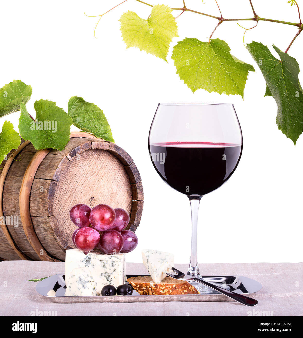 grapes on a barrel with corkscrew, wine glass and cheese isolated on a