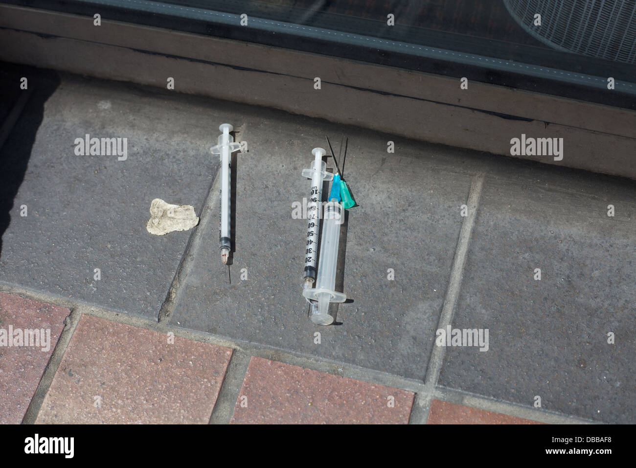 Drug addicts needles left in a city street. Stock Photo