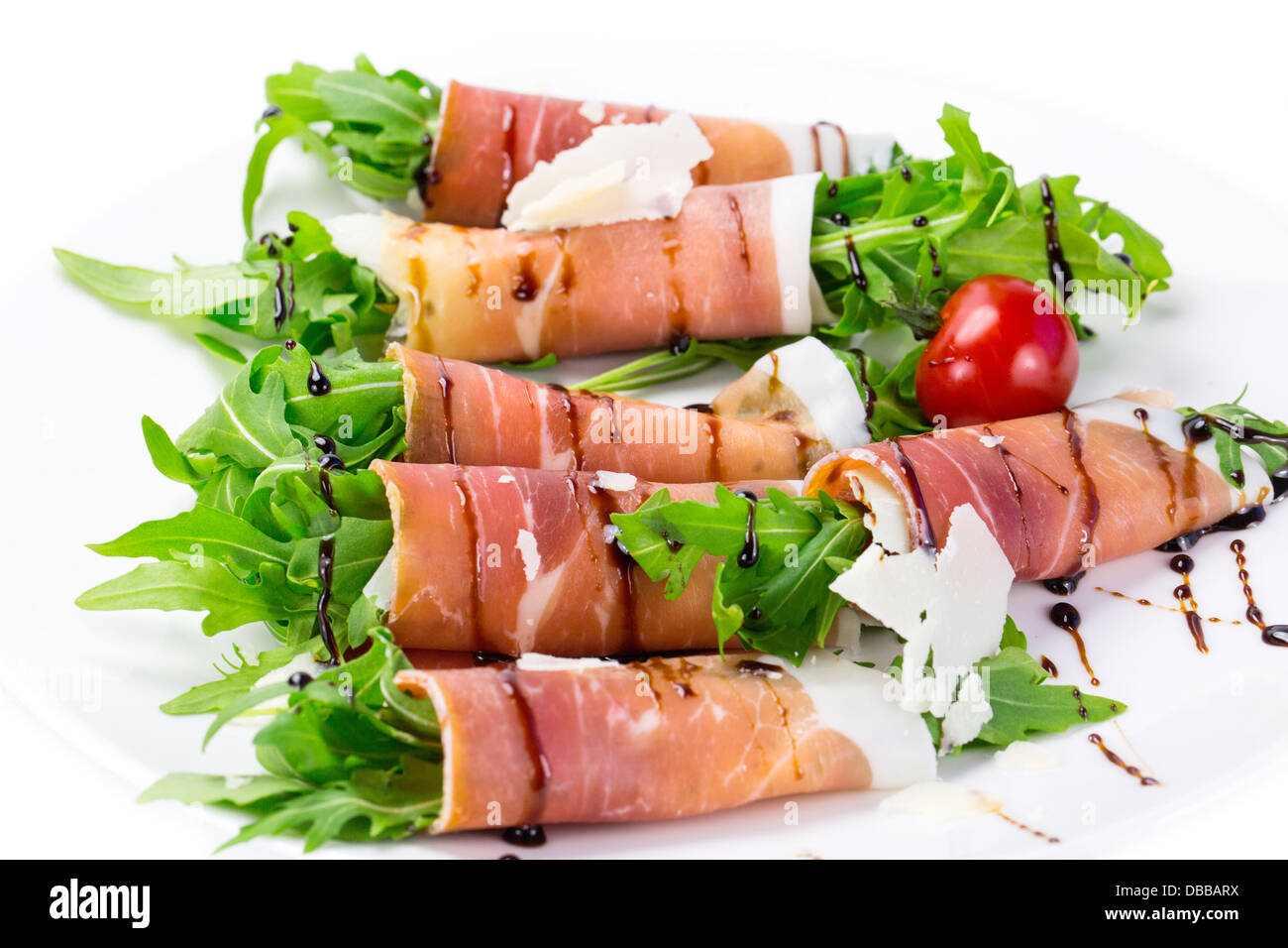 rolls of meat and greens on a white background in the restaurant Stock