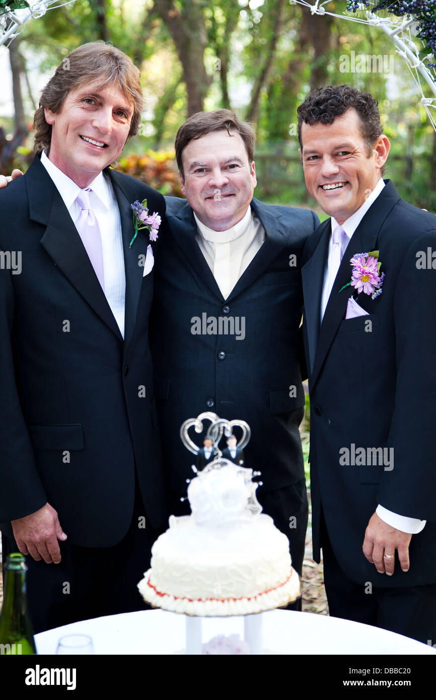 Handsome gay couple and their minister at their wedding.  Stock Photo