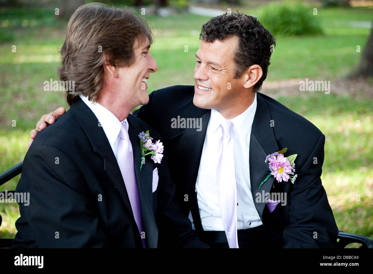 Gay couple celebrating their marriage together outdoors.  Stock Photo