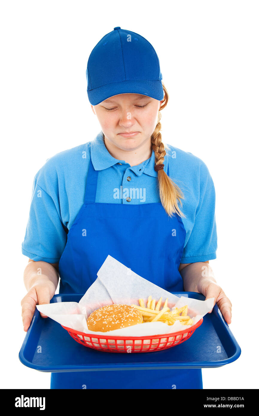 Teenage worker disgusted by a fast food burger and fries. Isolated on white. Stock Photo