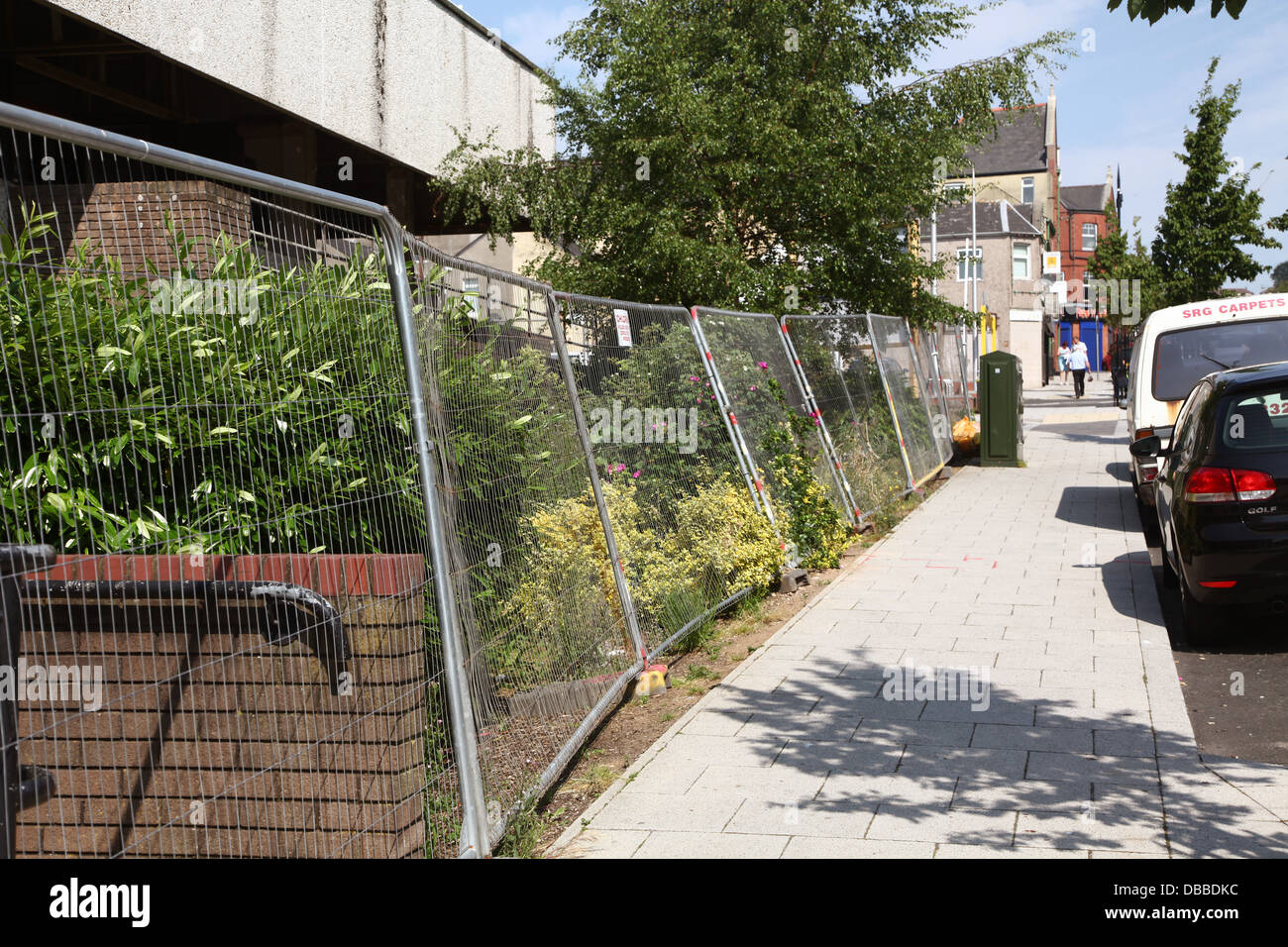 Heras temporary safety fencing beside Barry public library which was being demolished, July 2013 Stock Photo