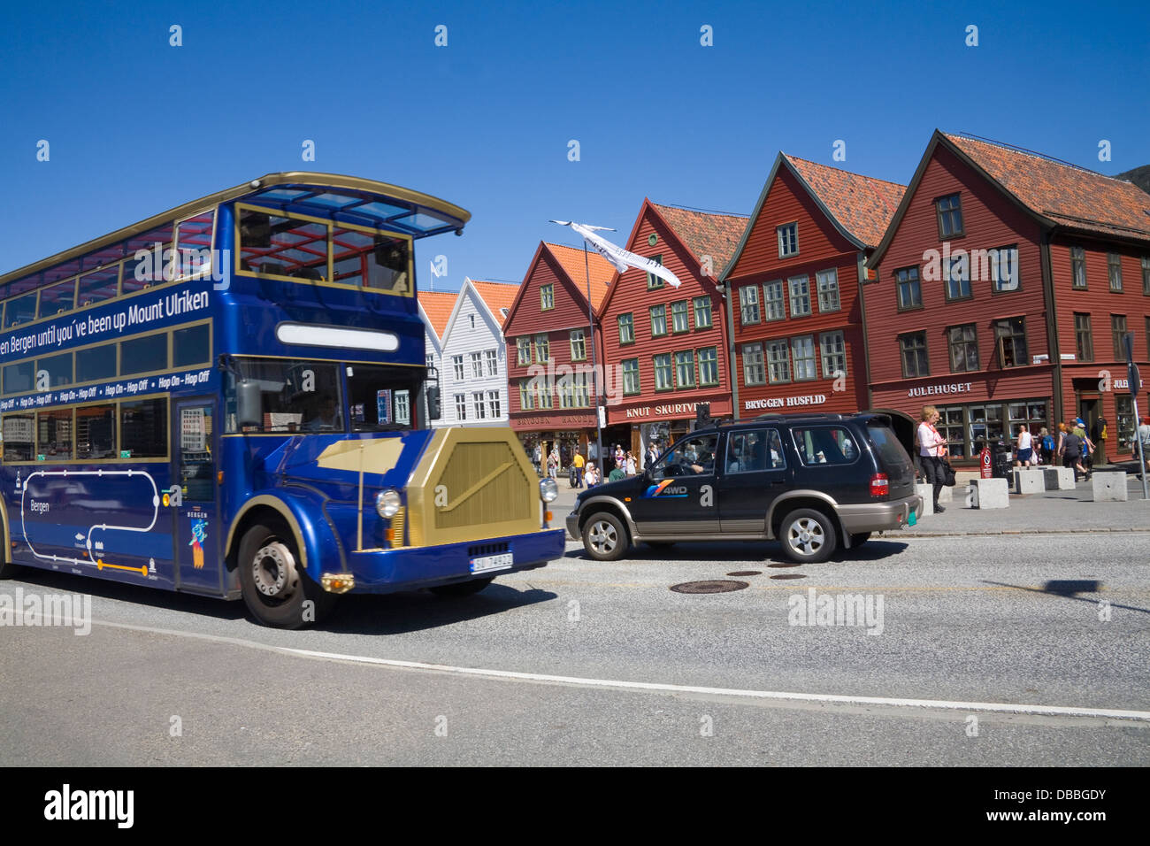 Bergen Norway Europe Old blue sightseeing bus passing Bryggen Hanseatic Wharf on city tour Stock Photo
