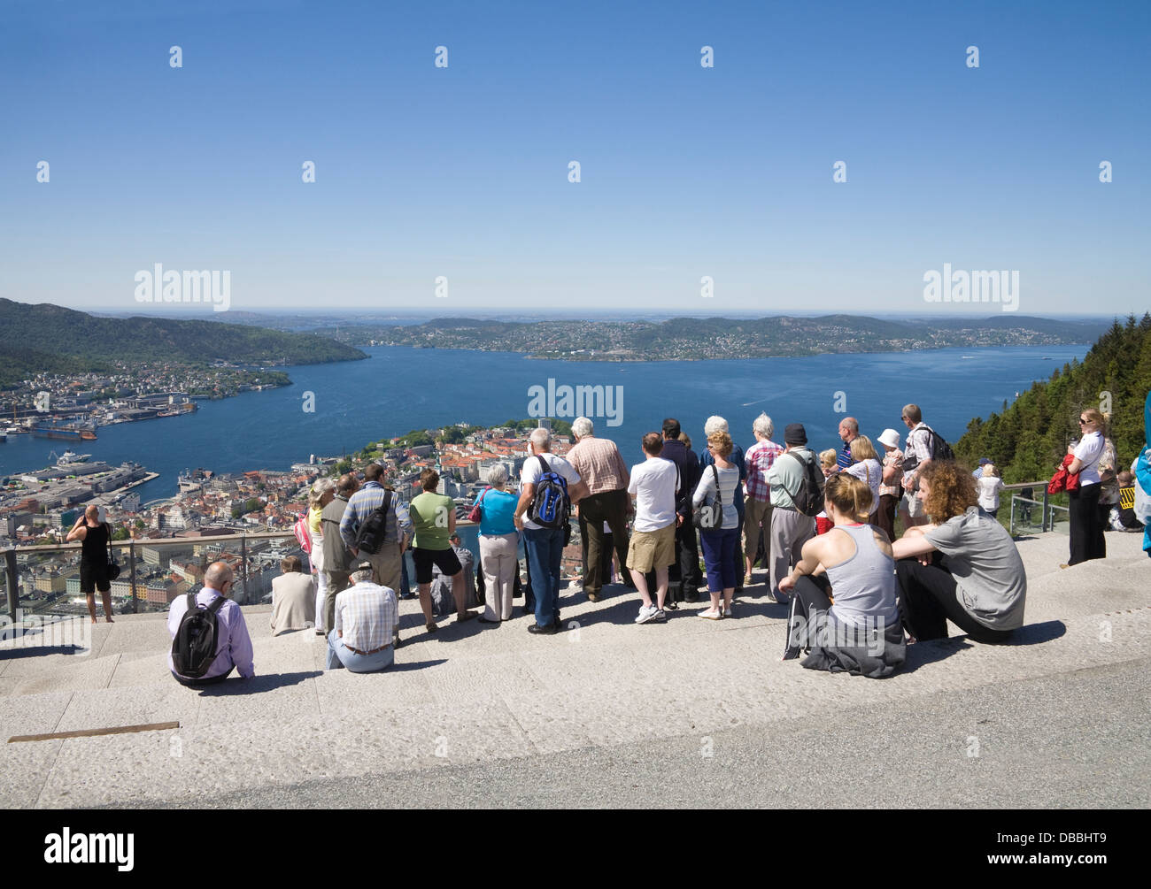 Bergen Norway Europe Tourists at the viewpoint on Mount Floyen looking down on the attractive city Stock Photo