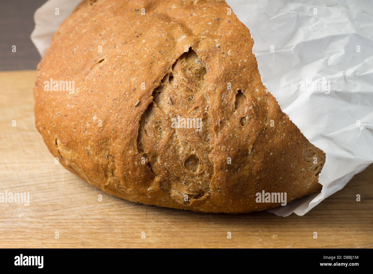 Freshly Bought whole grain wheat bread in Paper Bag Stock Photo