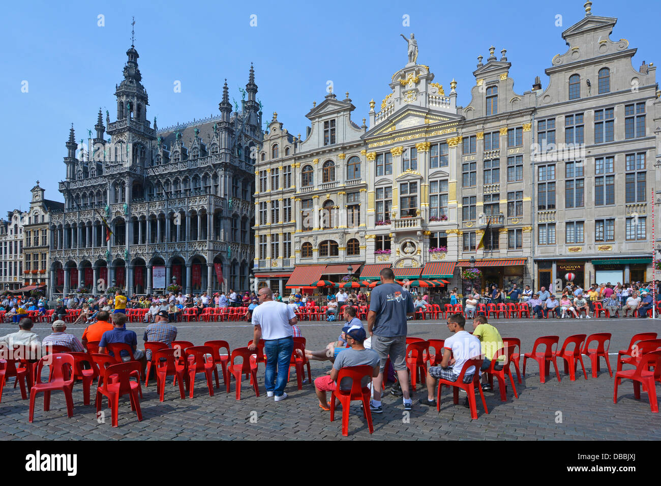 Spectators about to view Frisian handball gam in Grand Place, Museum of the City of Brussels (left) and Guildhalls (right) Stock Photo