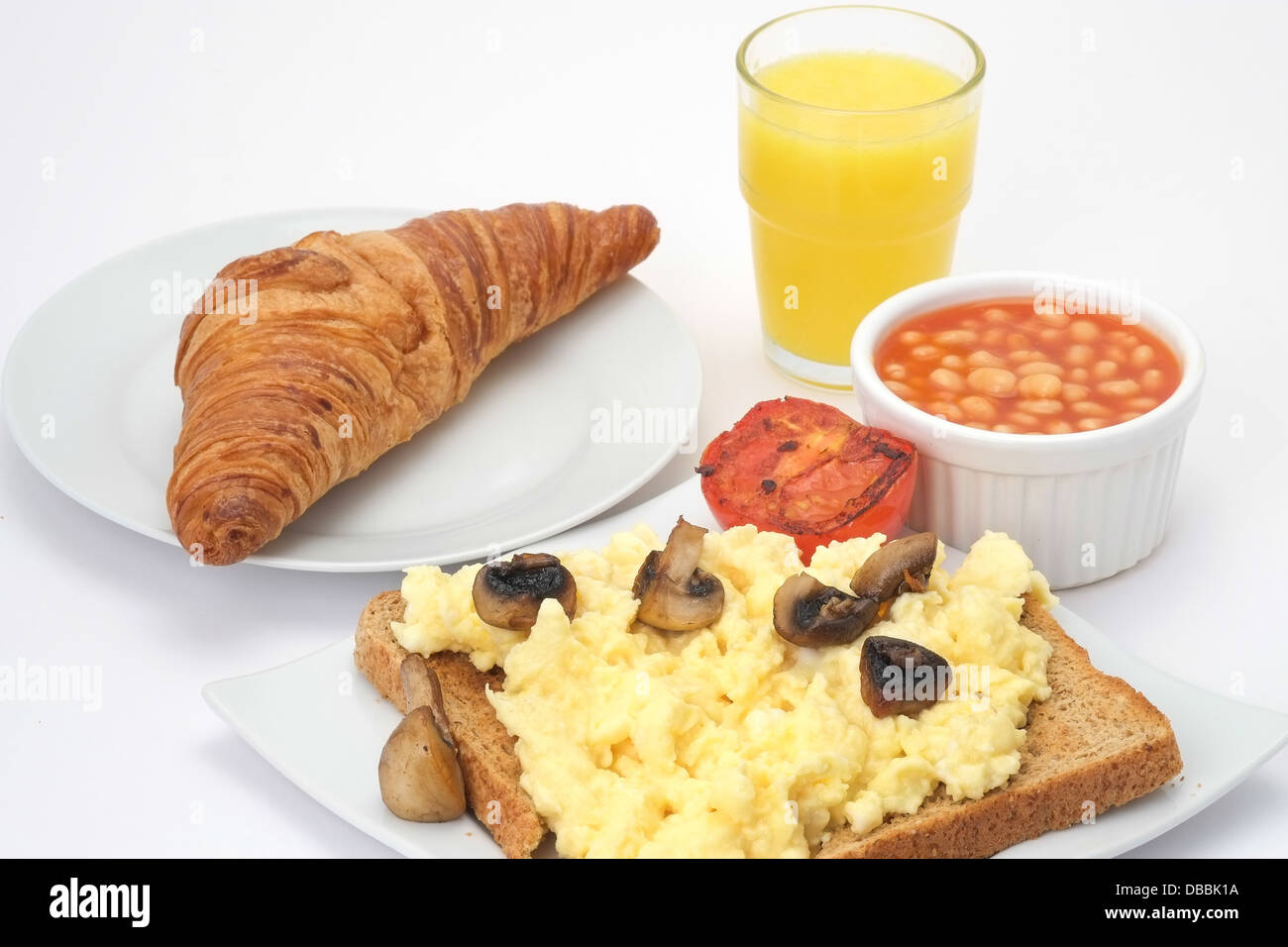 Scrambled Egg On Toast And Baked Beans With A Fresh Croissant And Orange Juice Stock Photo Alamy