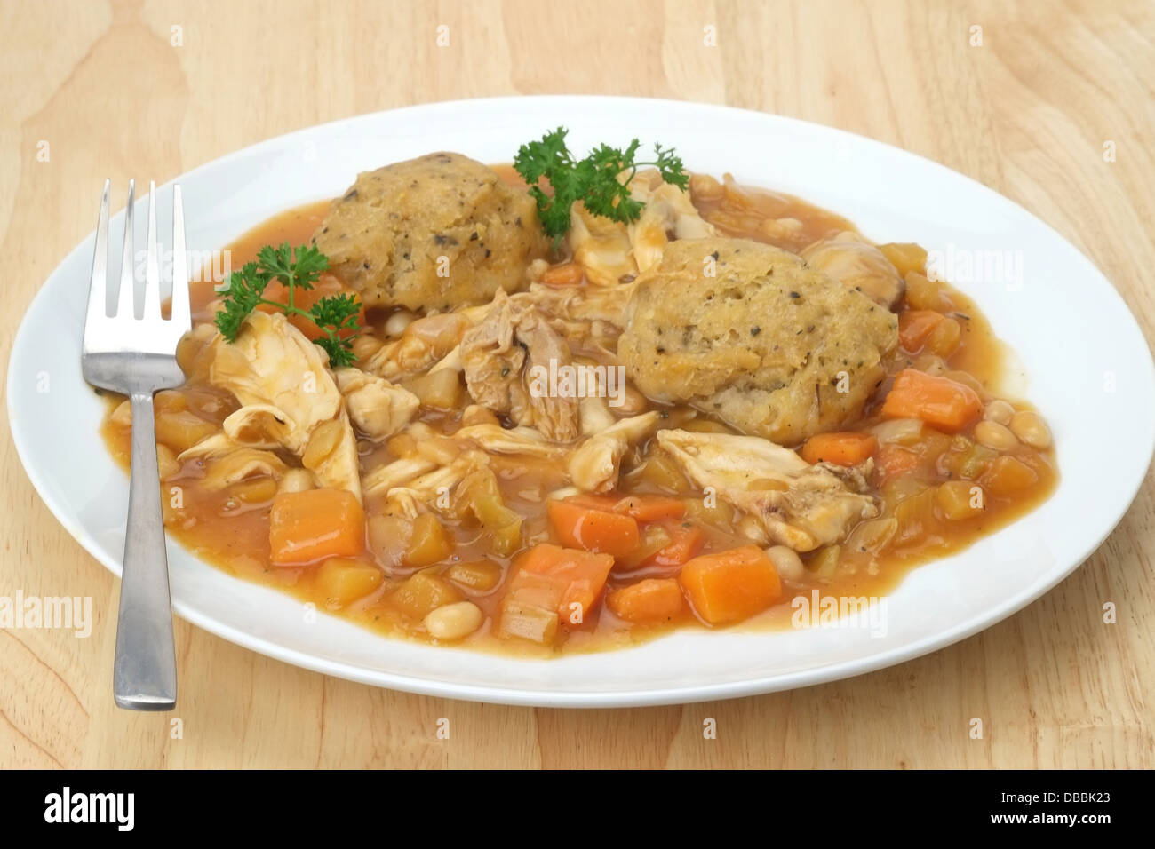 Chicken and vegetable casserole with sage and onion dumplings Stock Photo