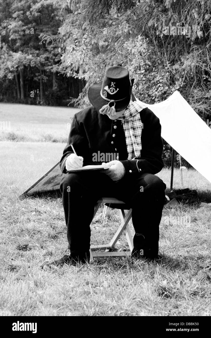 A young Civil War soldier reenactor at Christmas time writing home Stock Photo