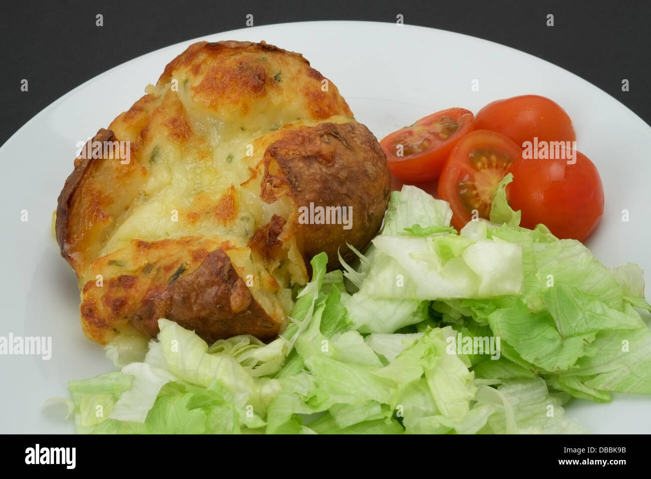 Baked jacket potato filled and cheese with a salad studio shot Stock Photo Alamy