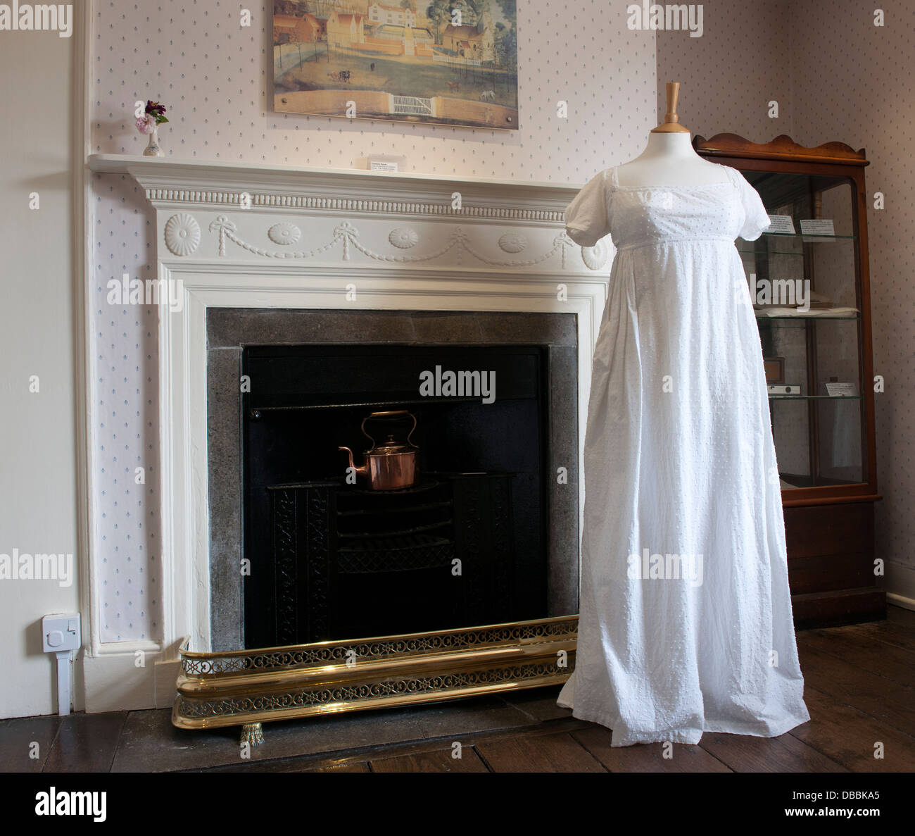 Jane Austen House Museum, Chawton, nr Alton, Hampshire, England, UK; view of dress on display in the dinning parlor. Stock Photo