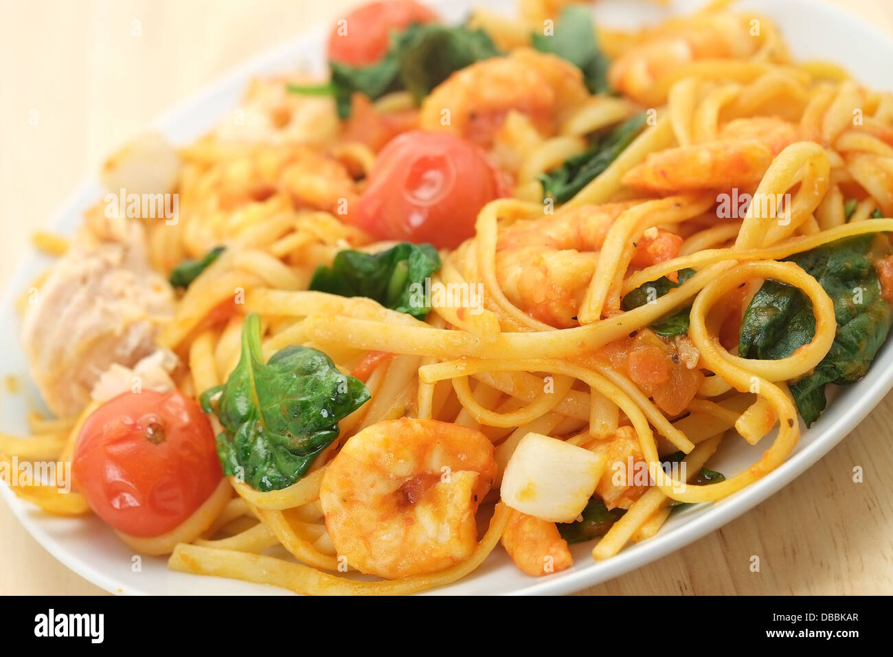 Seafood linguine with King Prawns, scallops, and salmon - shallow depth of field Stock Photo