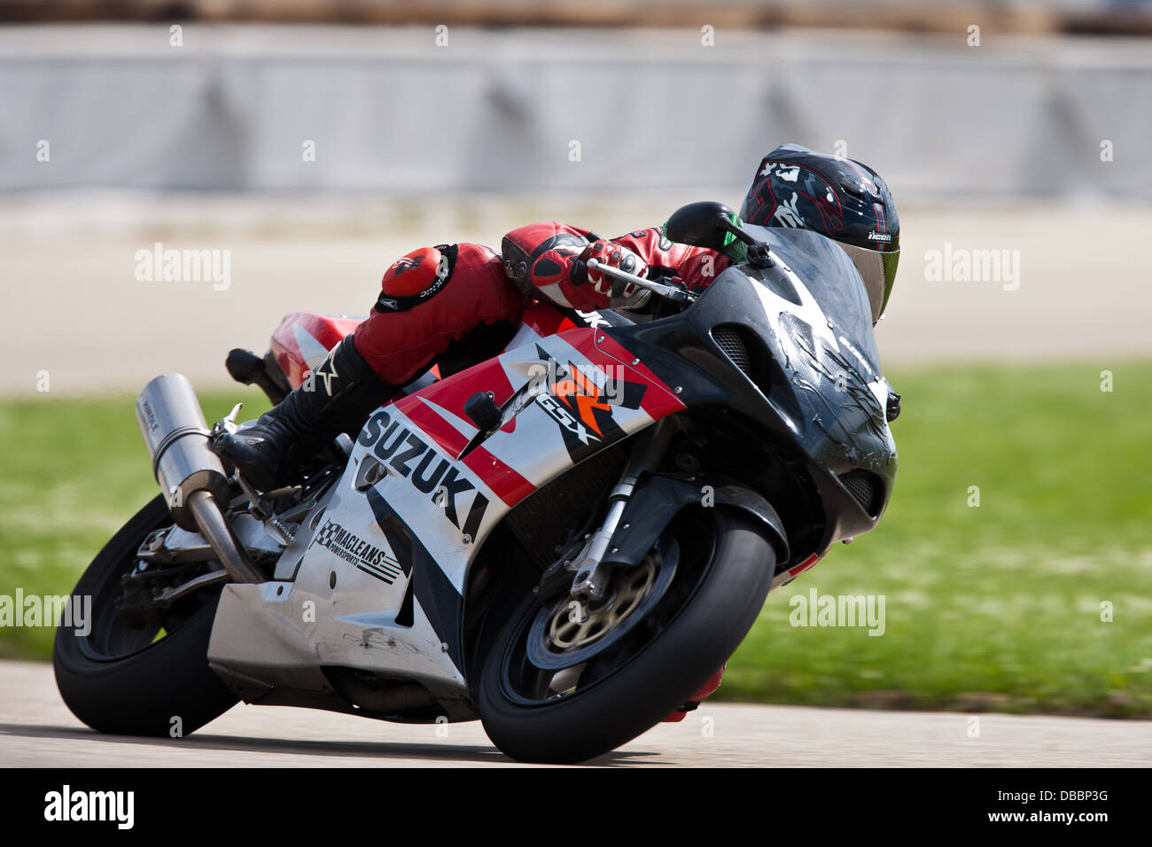 Motorcycle racer on track in left turn Stock Photo - Alamy