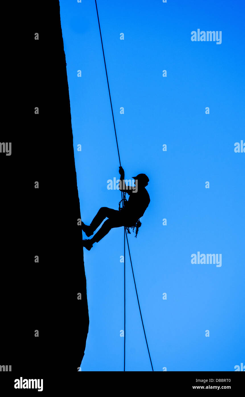 Rock climber repelling down cliff hires stock photography and images