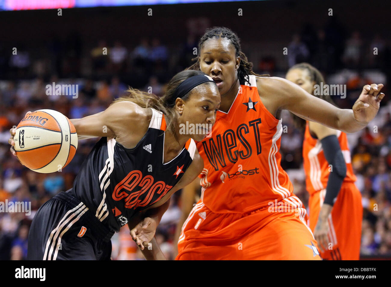 Uncasville, Connecticut, USA. 27th July, 2013. Eastern Conference forward Tamika Catchings (24) of the Indiana Fever drives to the basket against Western Conference forward Rebekkah Brunson (32) of the Minnesota Lynx during the 2013 WNBA All-Star game at Mohegan Sun Arena. The Western Conference defeated the East 102-98. Anthony Nesmith/CSM/Alamy Live News Stock Photo