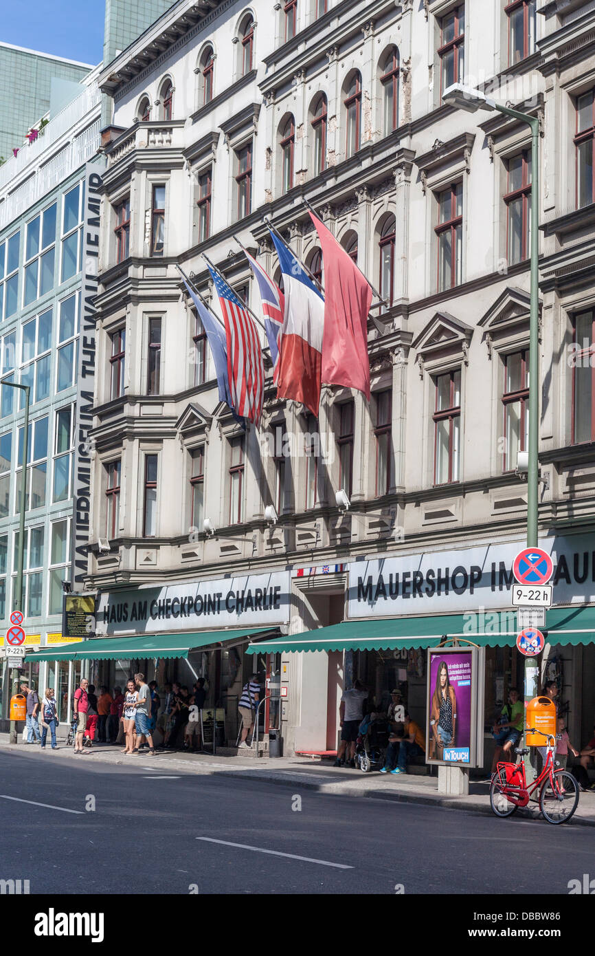 The Mauermuseum (Wall Museum) and allied flags at Checkpoint Charlie Border post, Friederichstrasse, Berlin Stock Photo