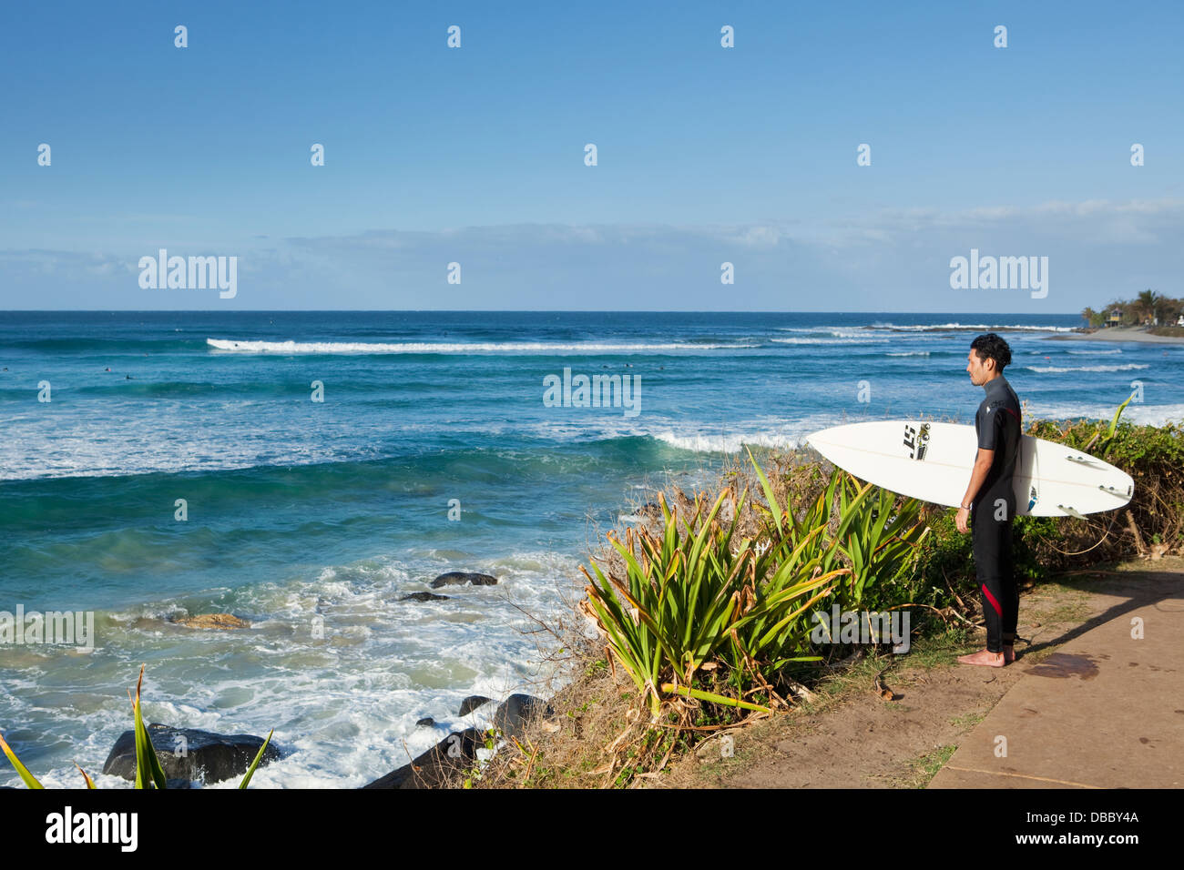 Surfer looking out to the waves at Greenmount Beach. Coolangatta, Gold Coast, Queensland, Australia Stock Photo