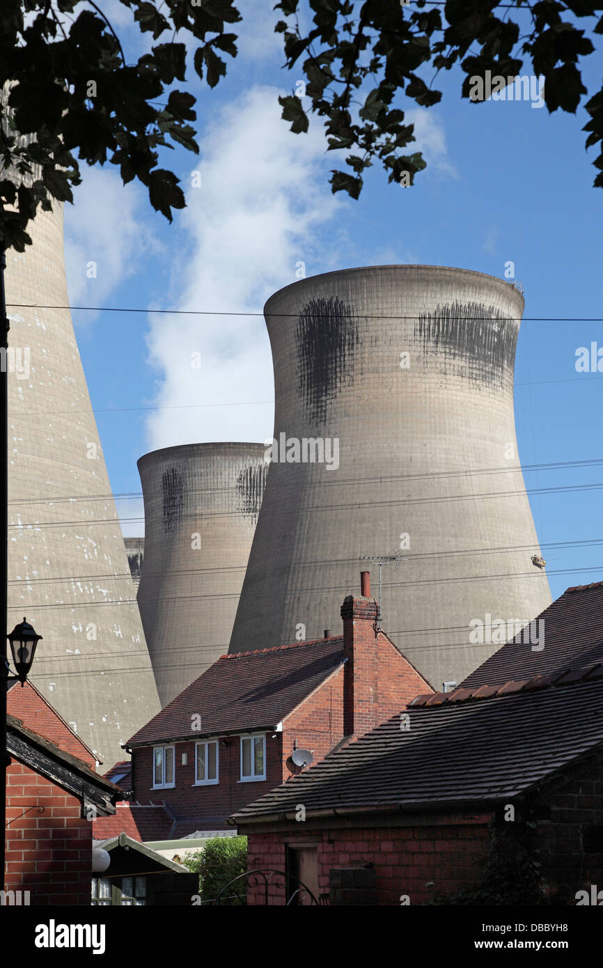 Houses in the shadow of the cooling towers of Ferrybridge C power station in West Yorkshire, UK. Due to close in 2016 Stock Photo