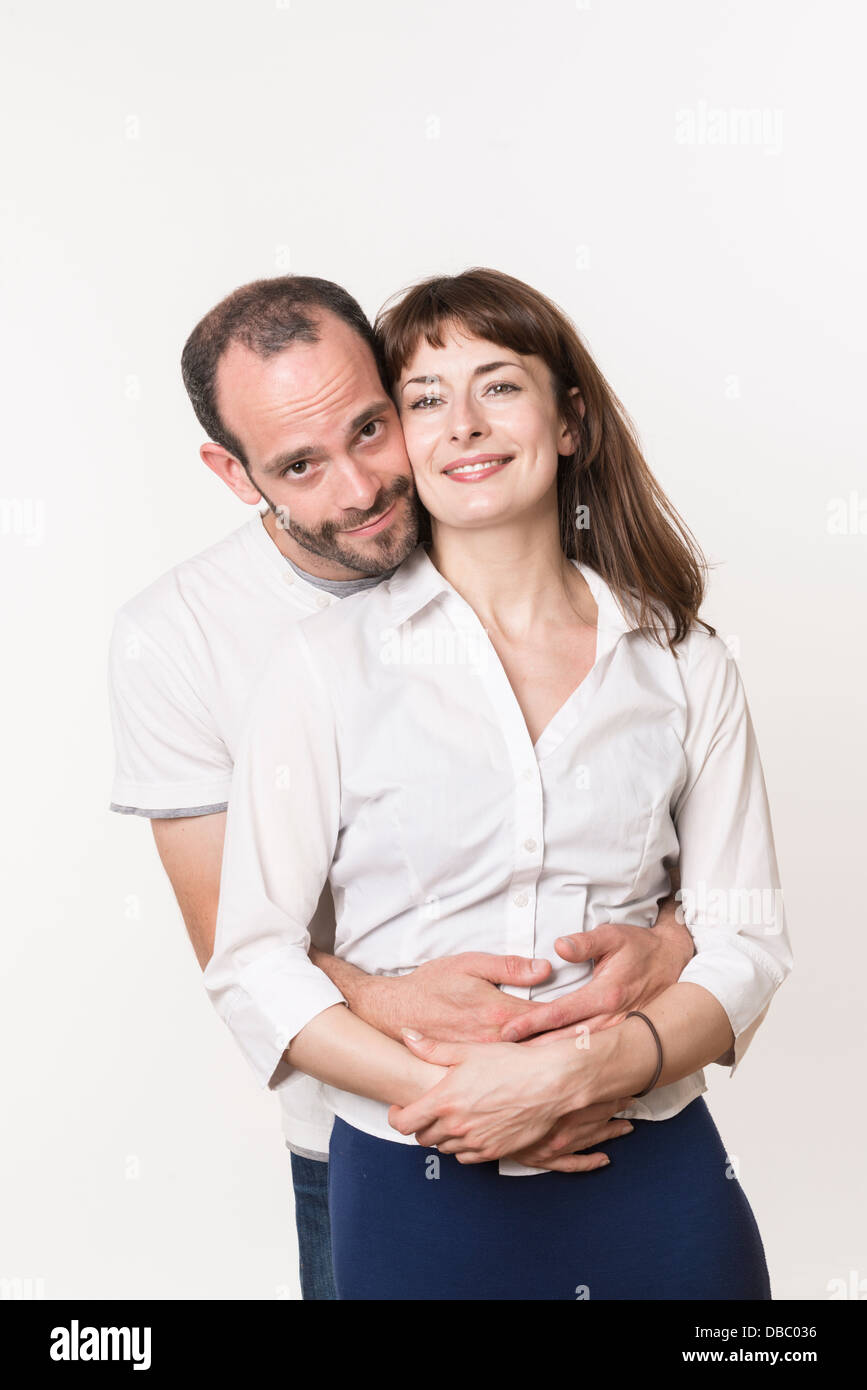 Young adult Caucasian couple happy together, man hugging woman from ...