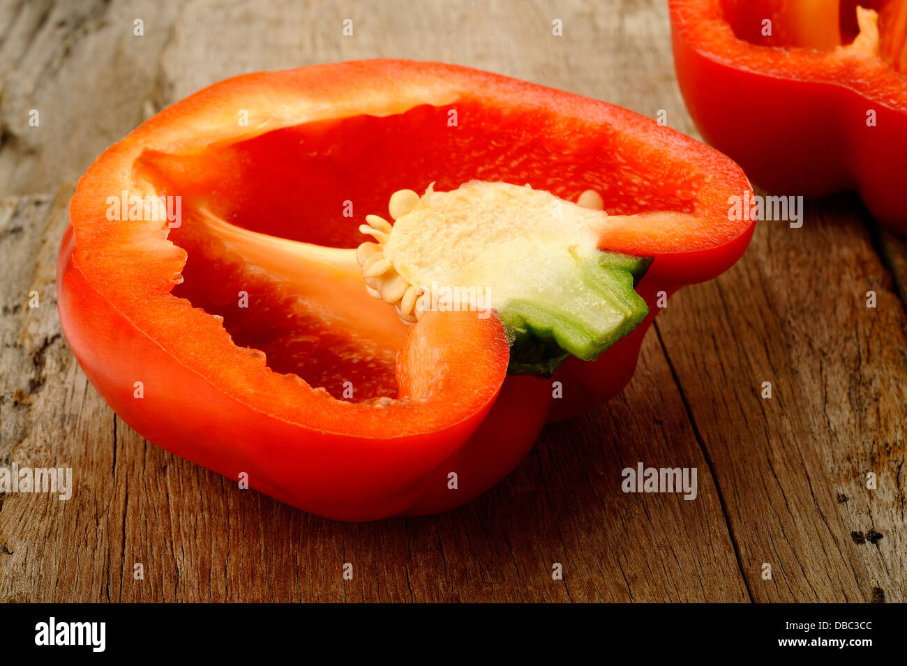 Cross section red bell pepper on wooden background Stock Photo