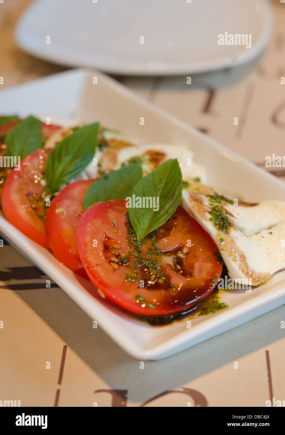 close up slice red tomato and mushroom with basil and delicious sauce Stock Photo