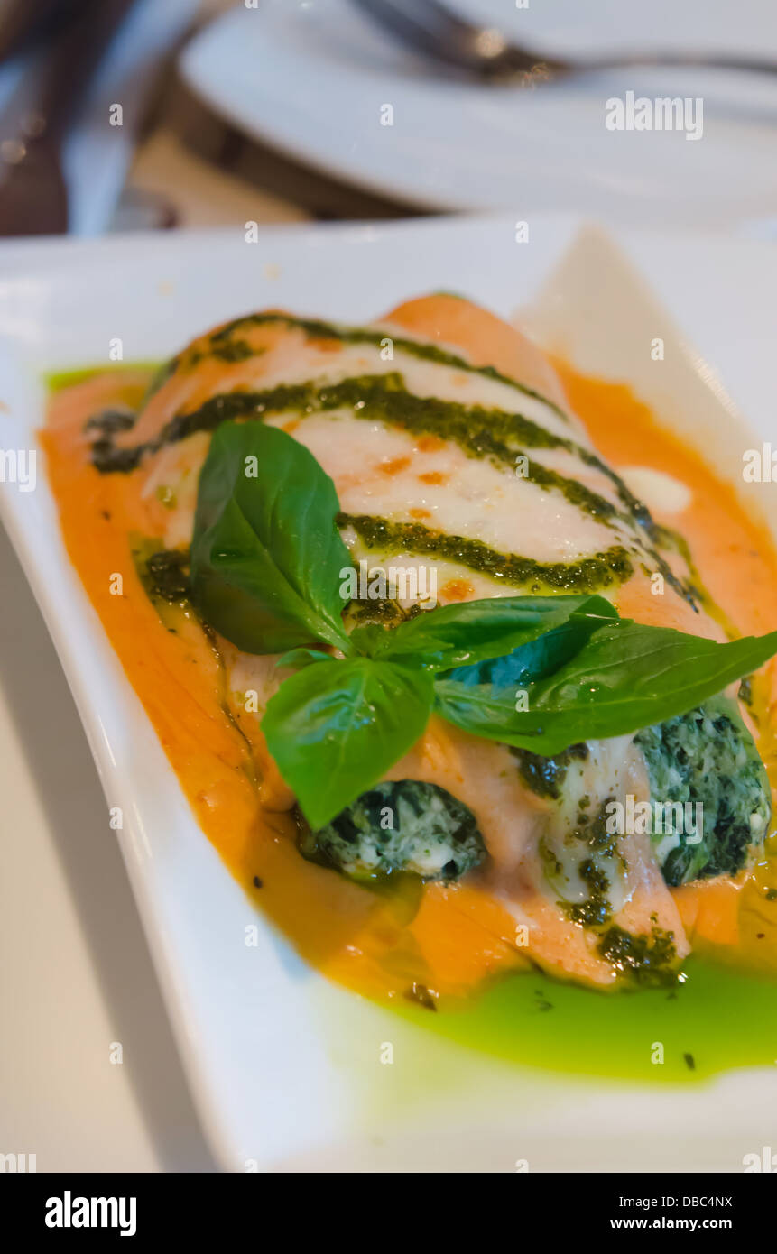 Baked Lasagna Rolled With Spinach Ricotta Cream Topped With Sweet Capsicum & Pesto Sauce Stock Photo