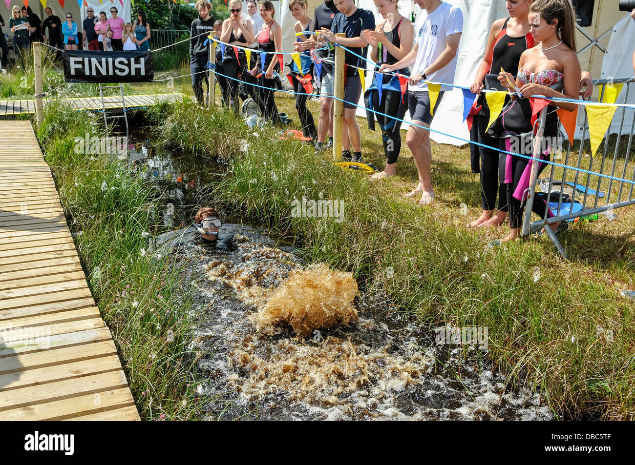 Dungannon, Northern Ireland, 28th July 2013 - Julia Calderwood swims backwards as she competes in the 2013 Northern Ireland Bog Snorkling Championship Credit:  Stephen Barnes/Alamy Live News Stock Photo