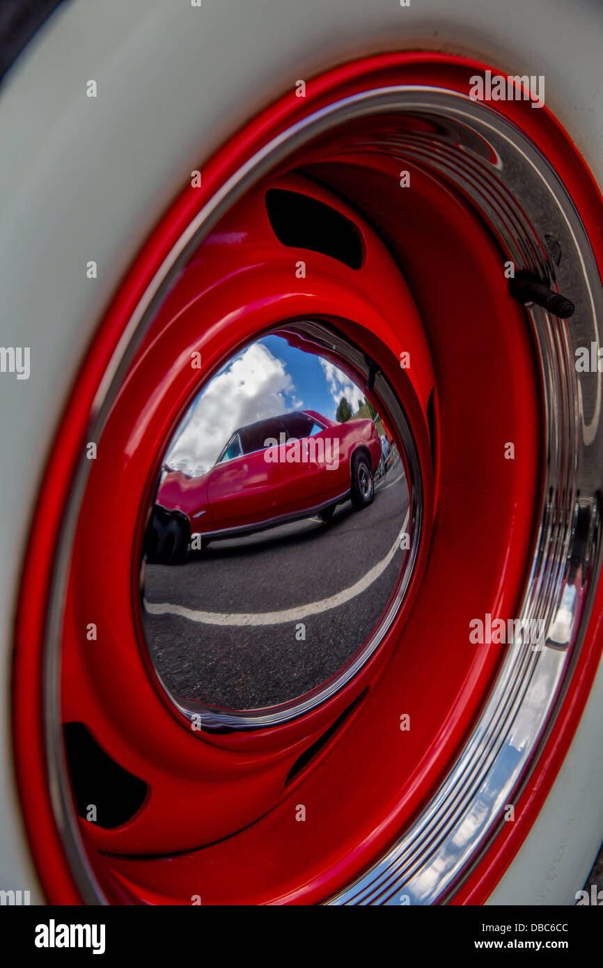 28/07/2013 1965 pontiac GTO reflection in the hubcap of a Chevrolet truck at the end of London to Southend classic car run Stock Photo