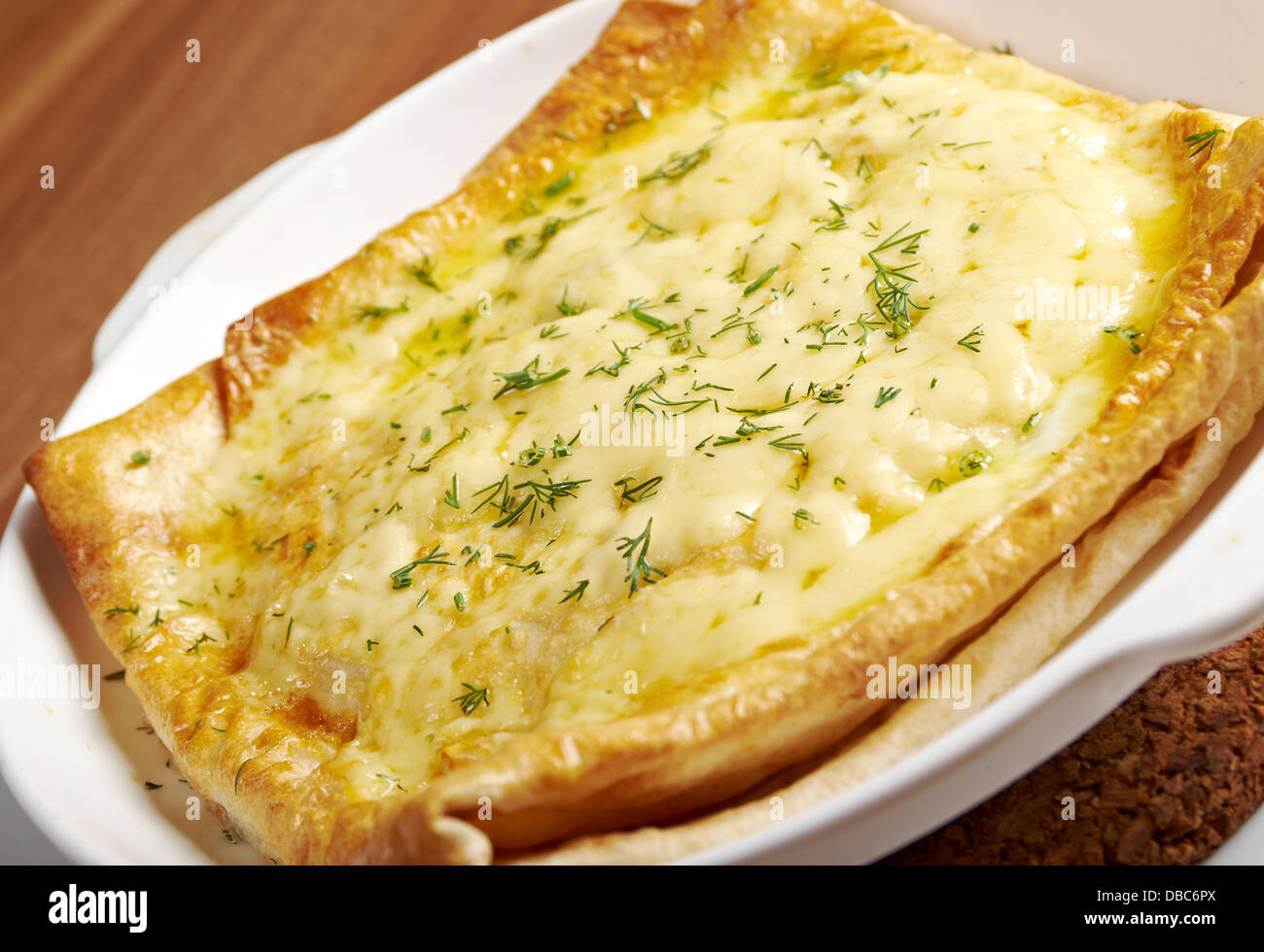 Qutab - baked lavash cheese pie .georgian bread and cheese suluguni  Stock Photo