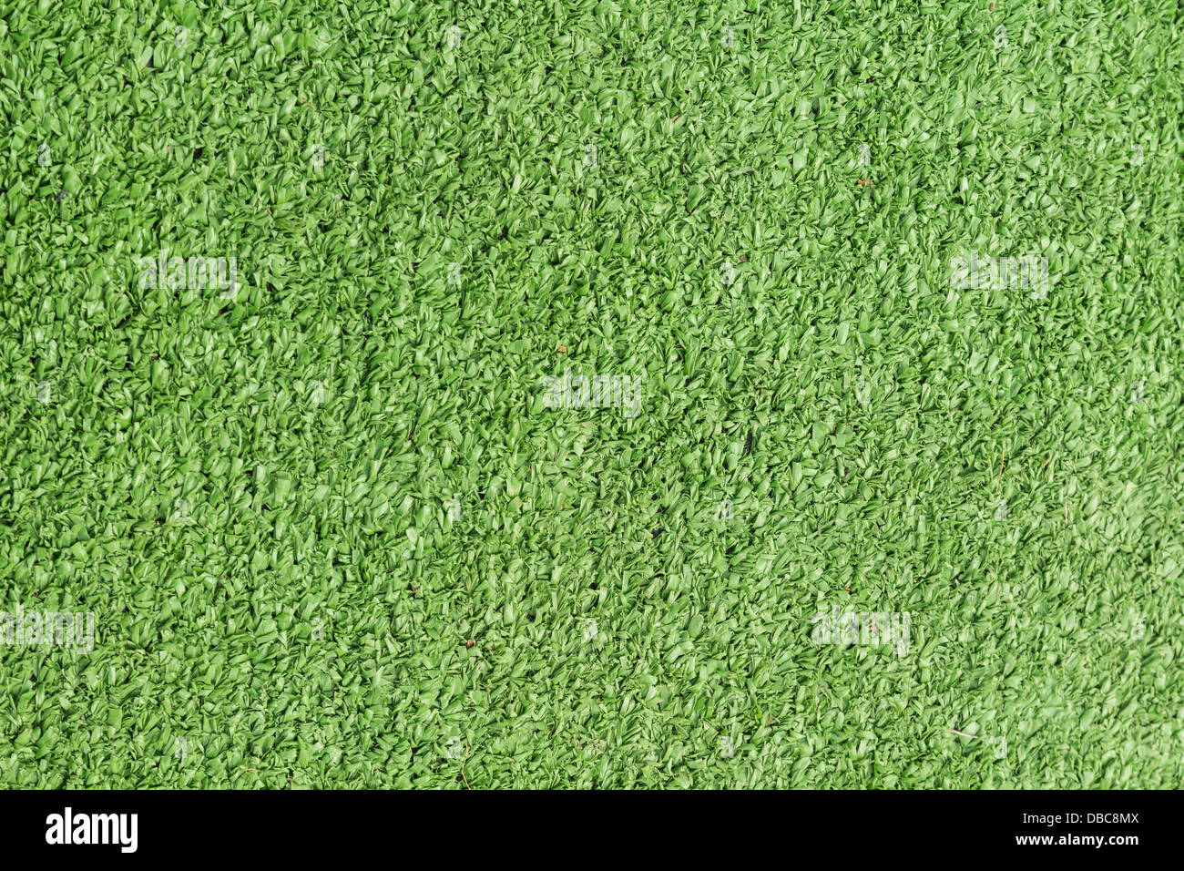 Background texture with fake grass in a public children playground, top view Stock Photo