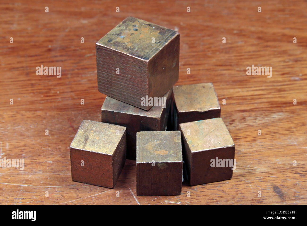 Several small cubes of the metal copper (Cu), as used in a UK high school. Stock Photo