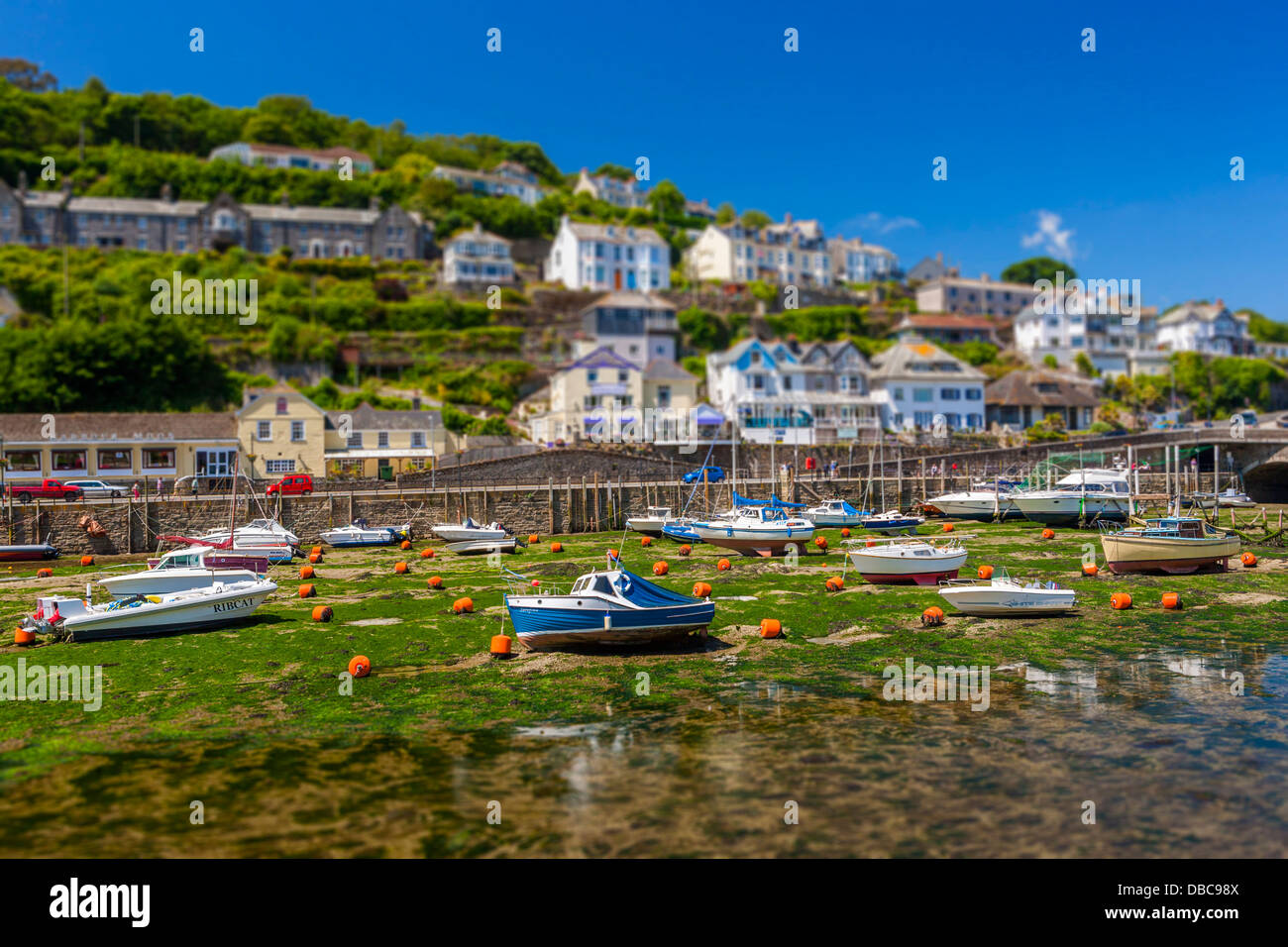 Fishing boats and sailing yachts moored in Looe harbour during low tide ...