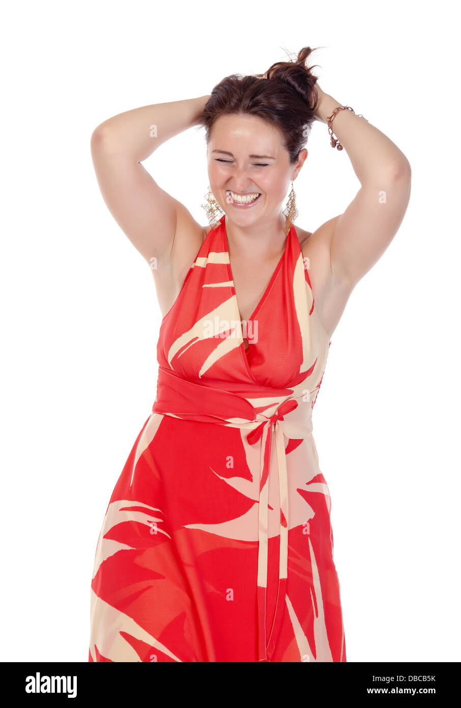 Portrait of a smiling young woman in red dress on white background ...