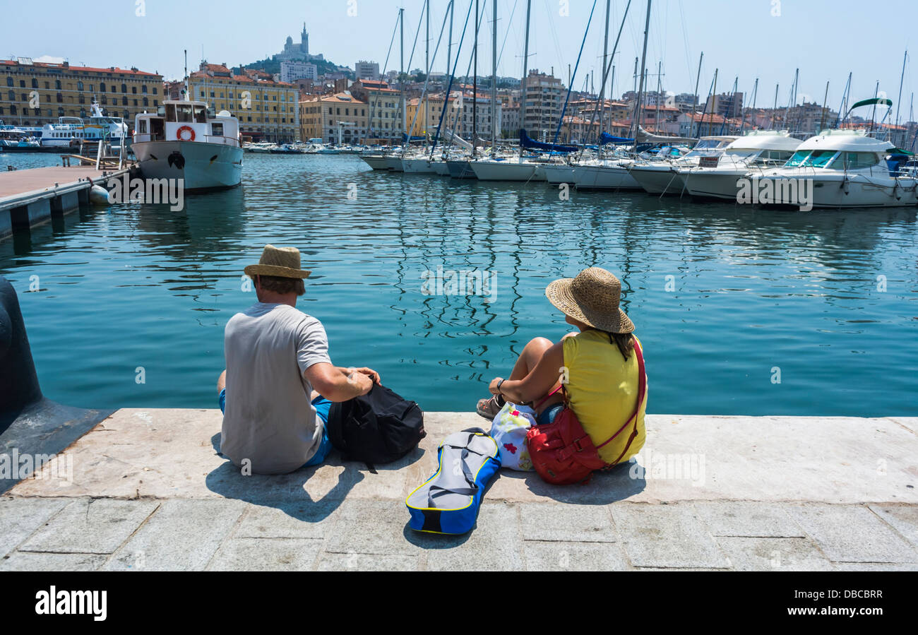 Marseille France, Tourist Couple, Rear, Sitting from behind on Harbour, 'Vieux Port' area, Daytime Stock Photo