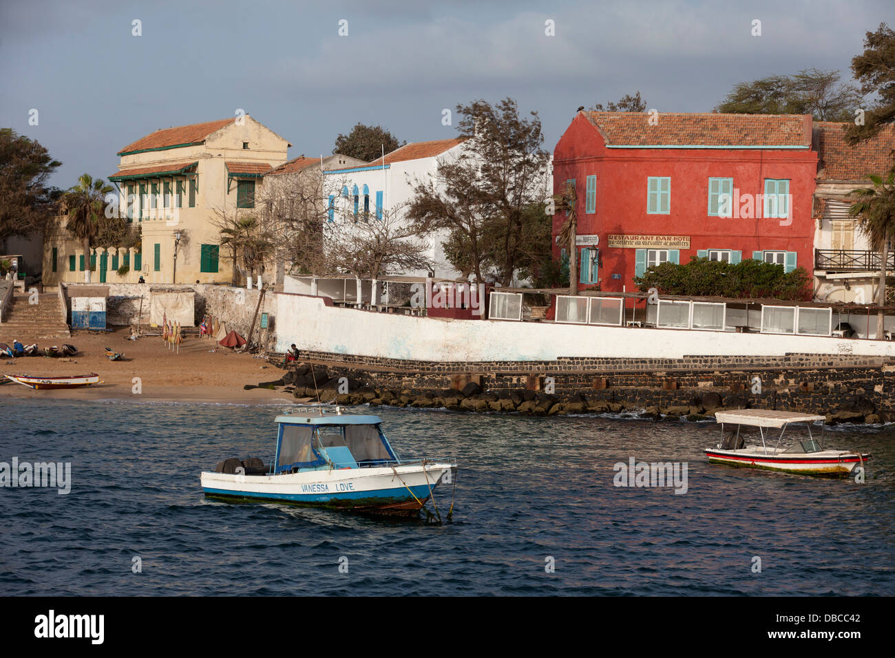Houses on Goree Island Waterfront, Senegal. Hostellerie du Chevalier de Boufflers (red building), a small hotel, on the right. Stock Photo
