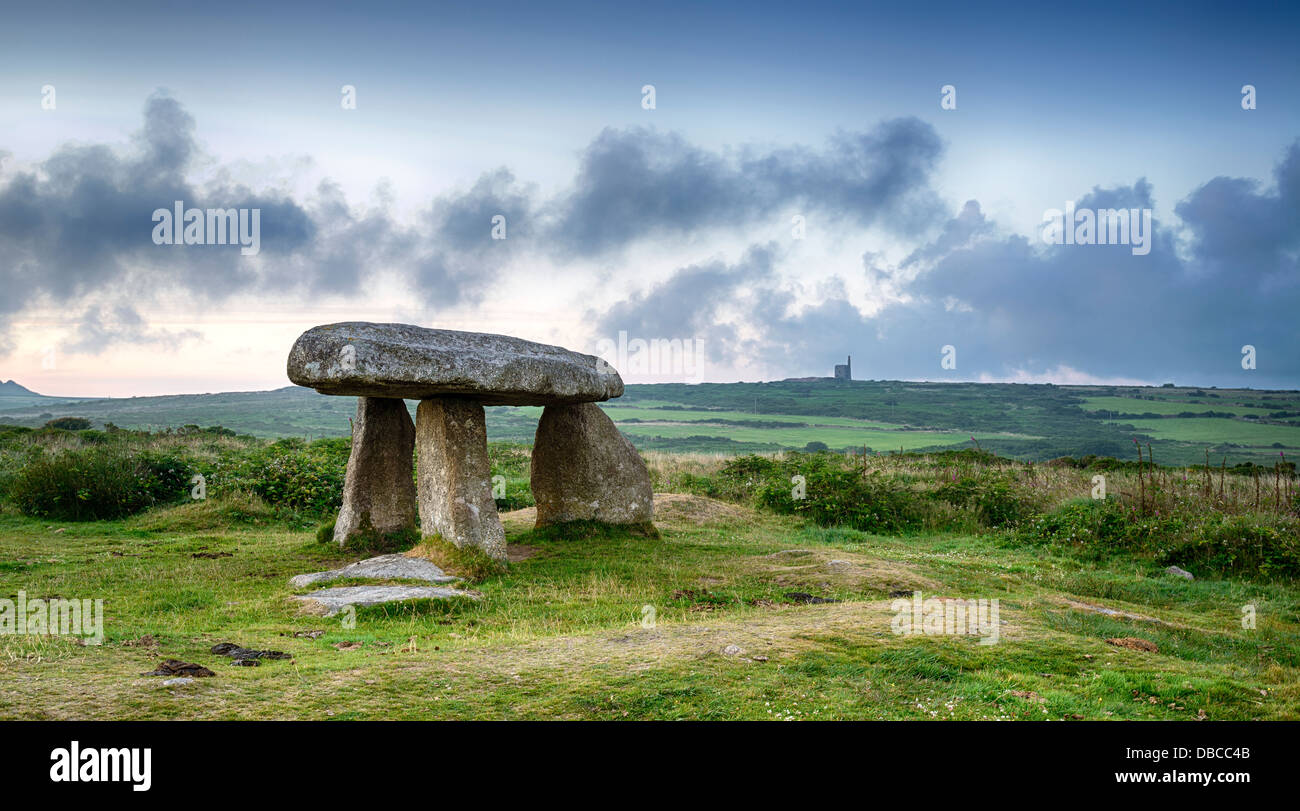 Lanyon Quoit near Madron on the Lands End Peninsula in Cornwall, with a Cornish tin mine in the distance. Stock Photo
