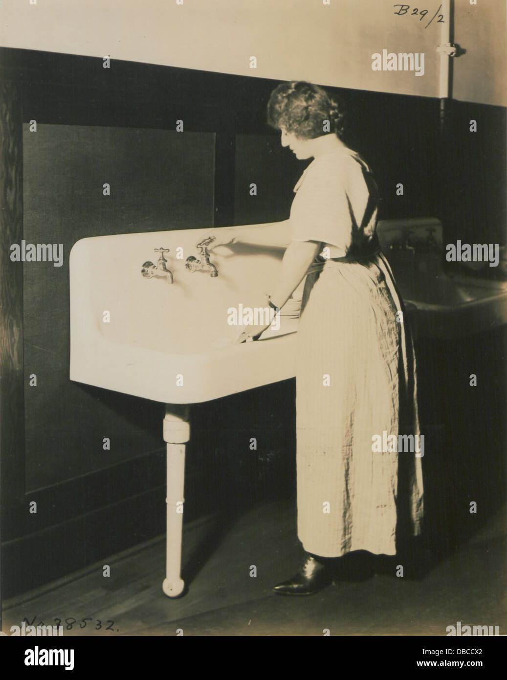 This photograph features a living model posed alongside plumbing ...
