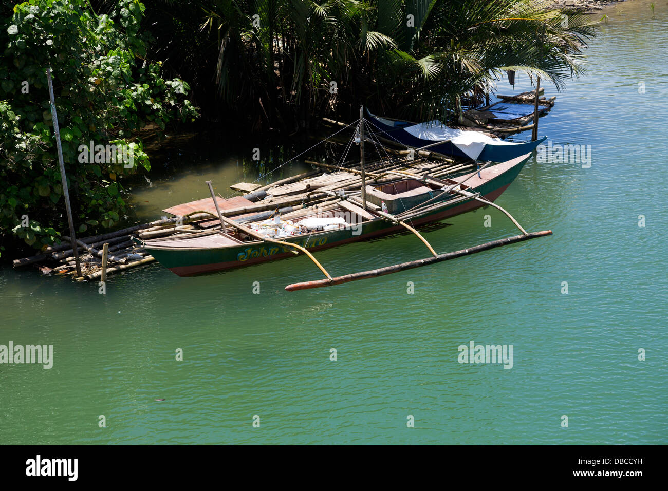 Traditional Outrigger Boat on the Riverbanks on Bohol Island, Philippines Stock Photo
