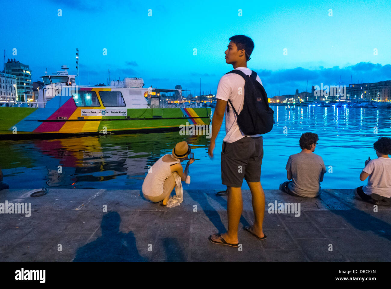 Marseille France, Europe Chinese Tourists Visiting Vieux Port area, Street Scenes, at Dusk, city colour Stock Photo