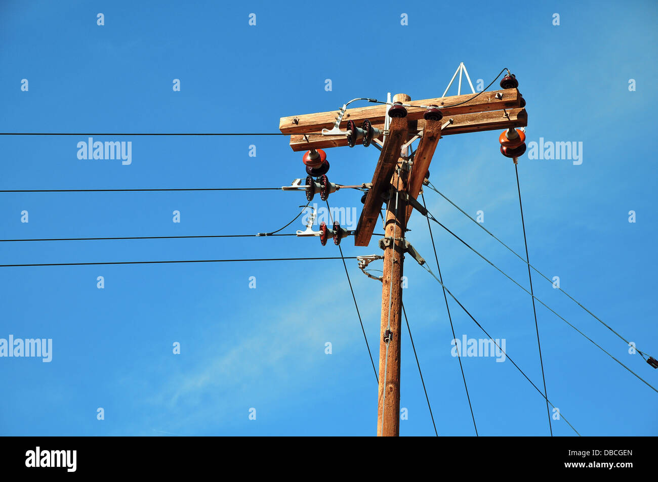 Electric pole in front of a clouded blue sky Stock Photo - Alamy