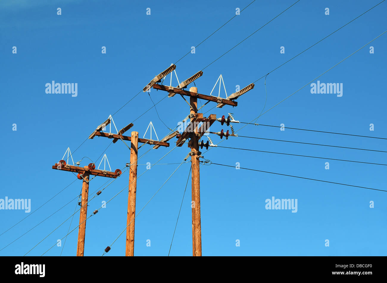 Electric pole in front of a clouded blue sky Stock Photo - Alamy
