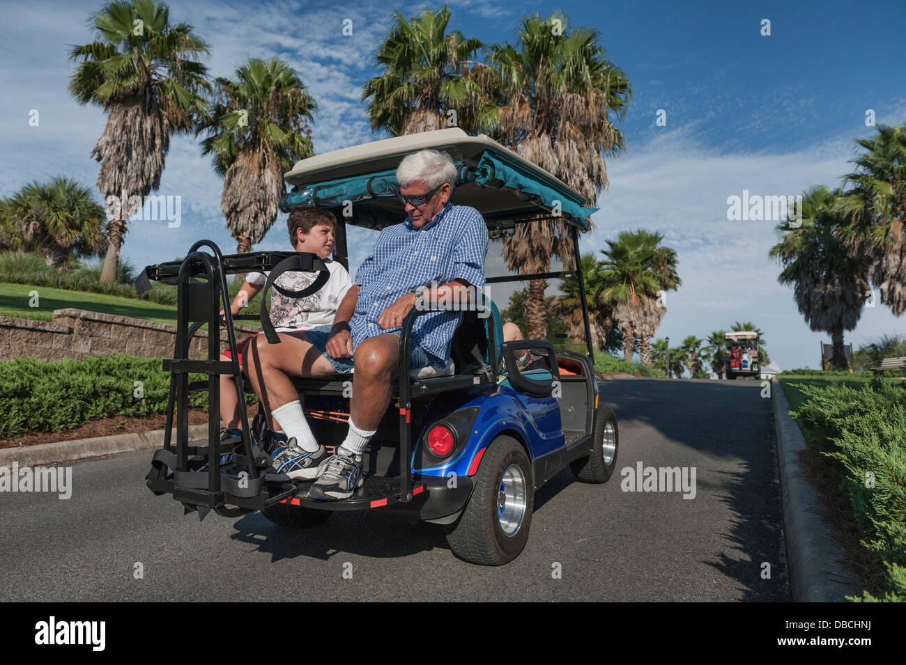 A family making it's way through one of the many golf cart paths in the